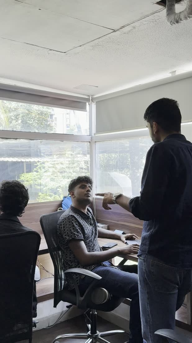 Manan Mehta going through a screen with a colleague at the MarketinCrew office