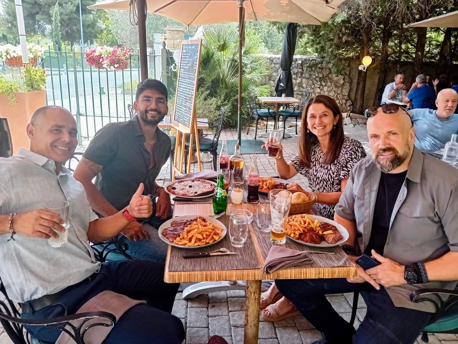 Manan Mehta at an outdoor restaurant table with four people over lunch