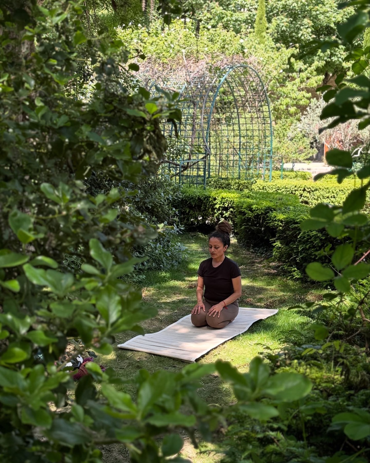 A client photographed practising yoga in a garden in France during a content shoot