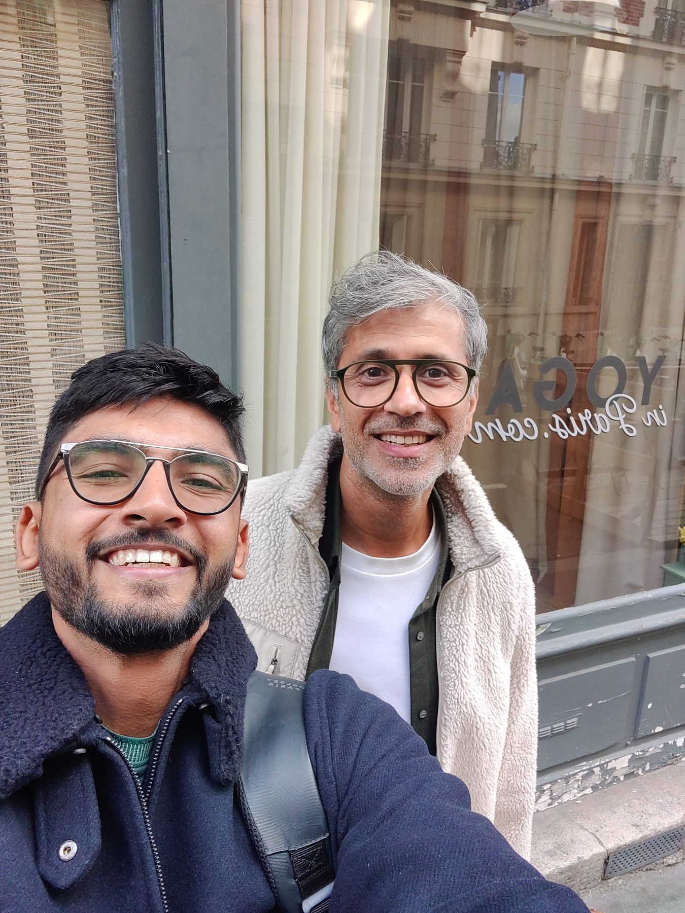 Manan Mehta with a client on the street outside his shop in France