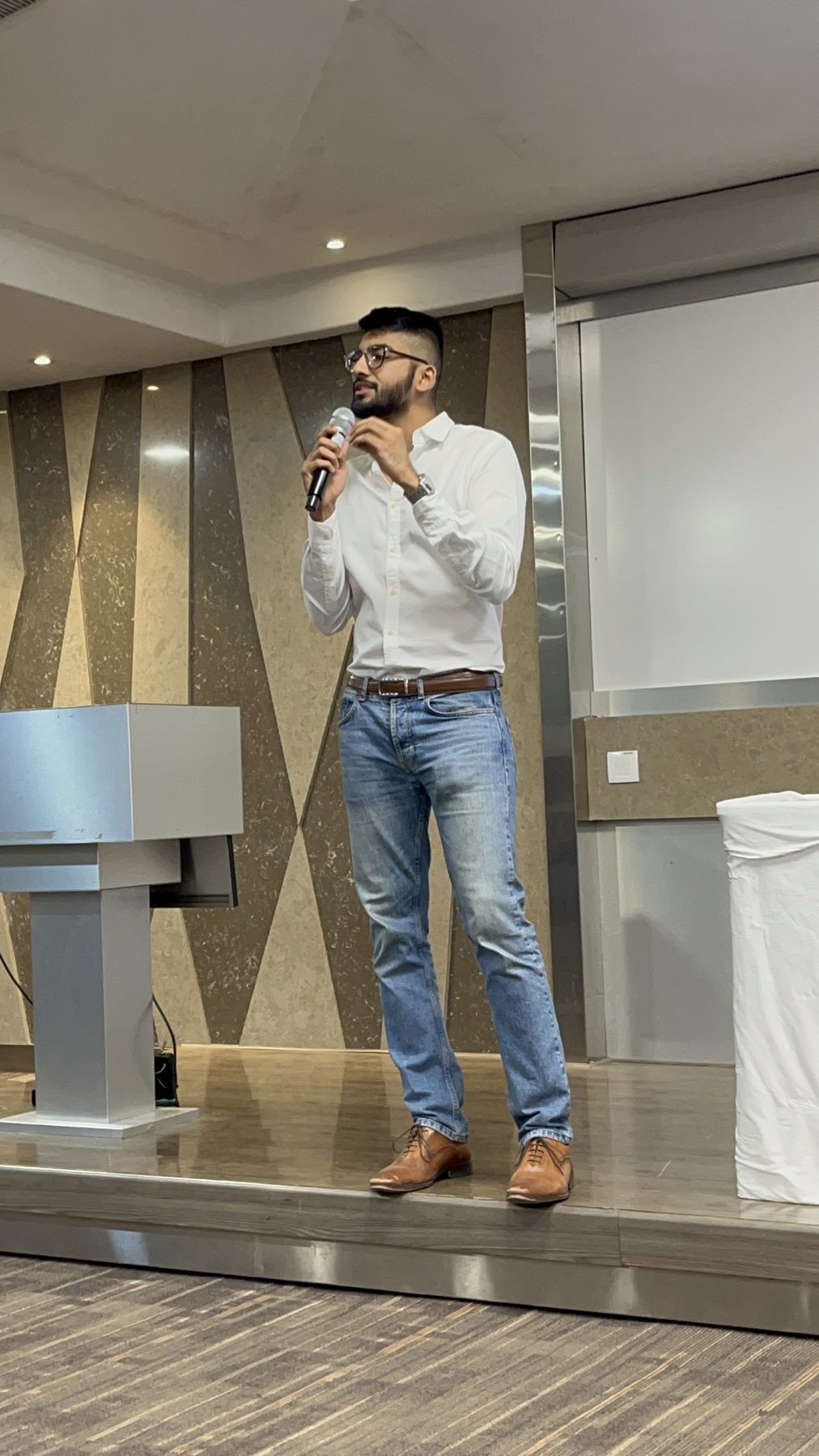 Manan Mehta speaking on stage at an Advertising and Marketing Circle session