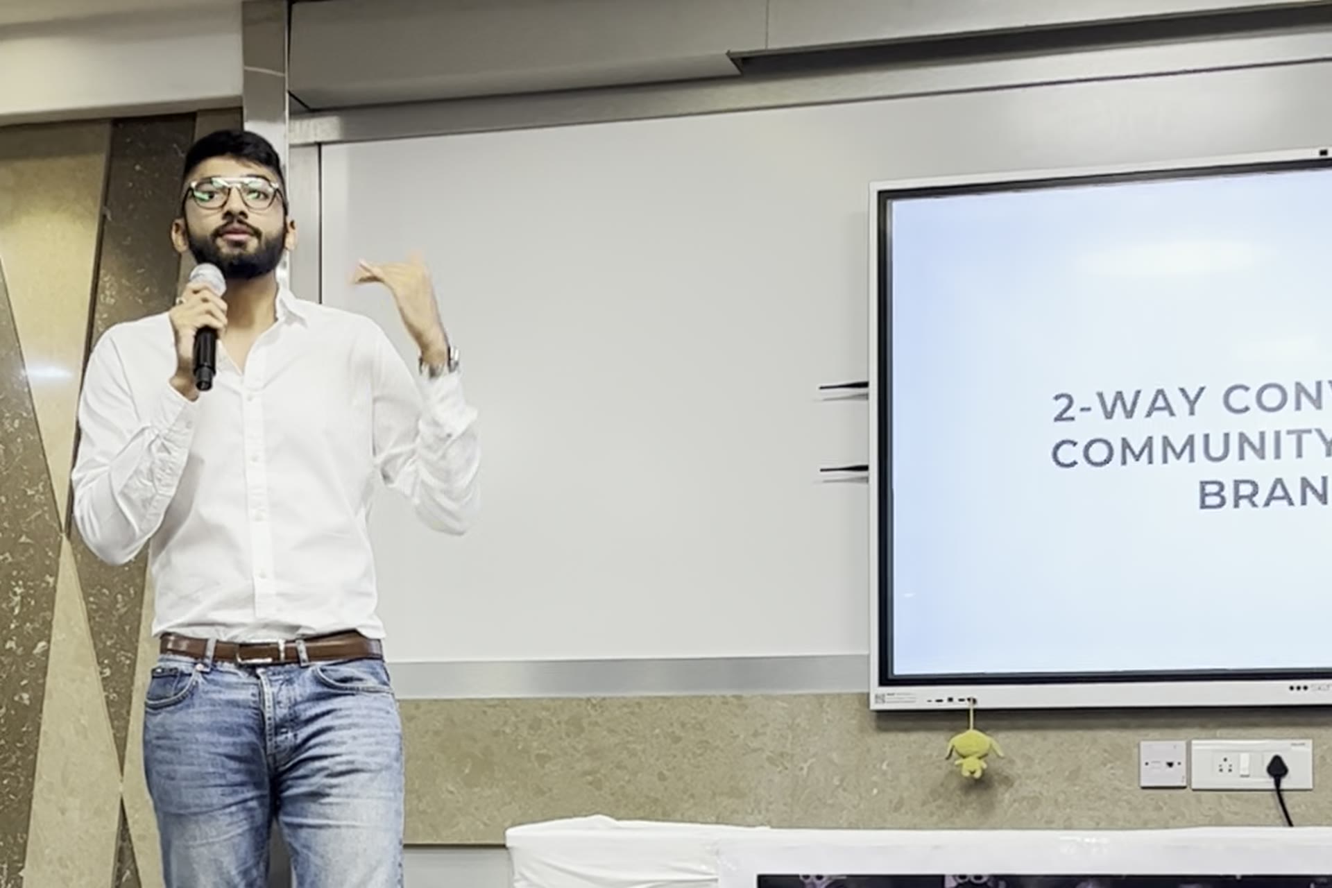 Manan Mehta teaching a marketing session, microphone in hand