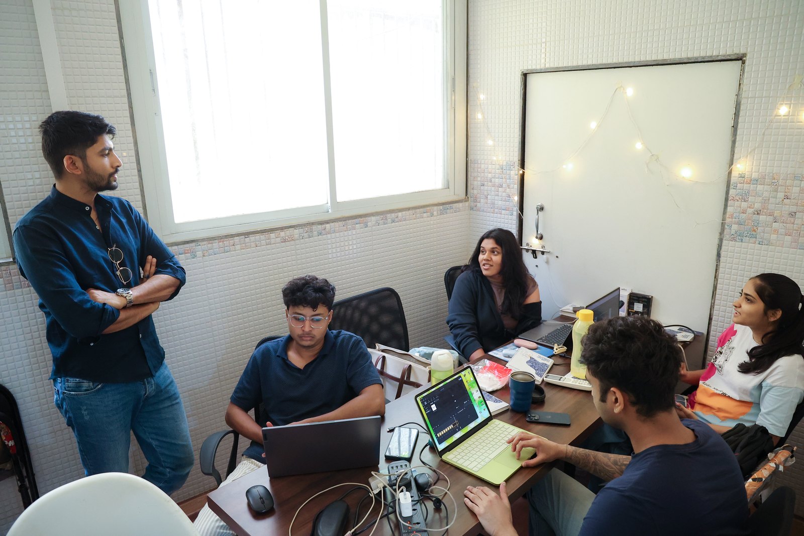 Manan Mehta with the MarketinCrew team at their desks in the Mumbai office