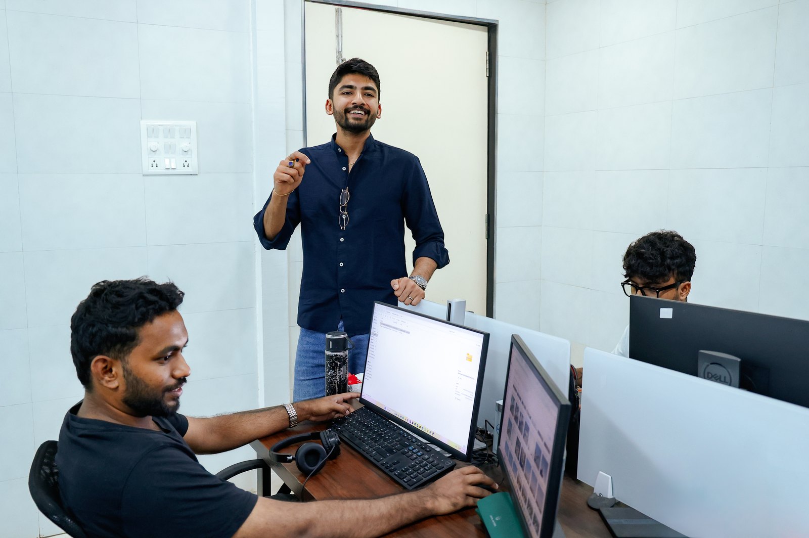 Manan Mehta reviewing design work on screen with a designer