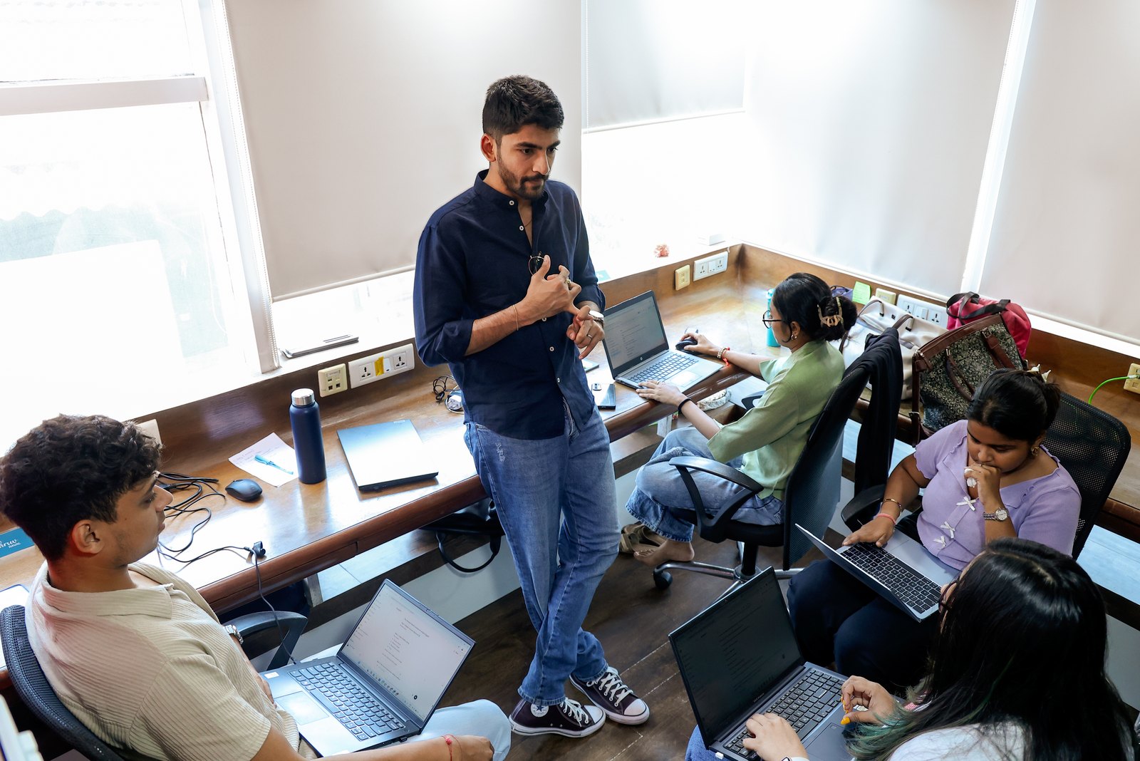 Manan Mehta briefing the team at their laptops in the Mumbai office