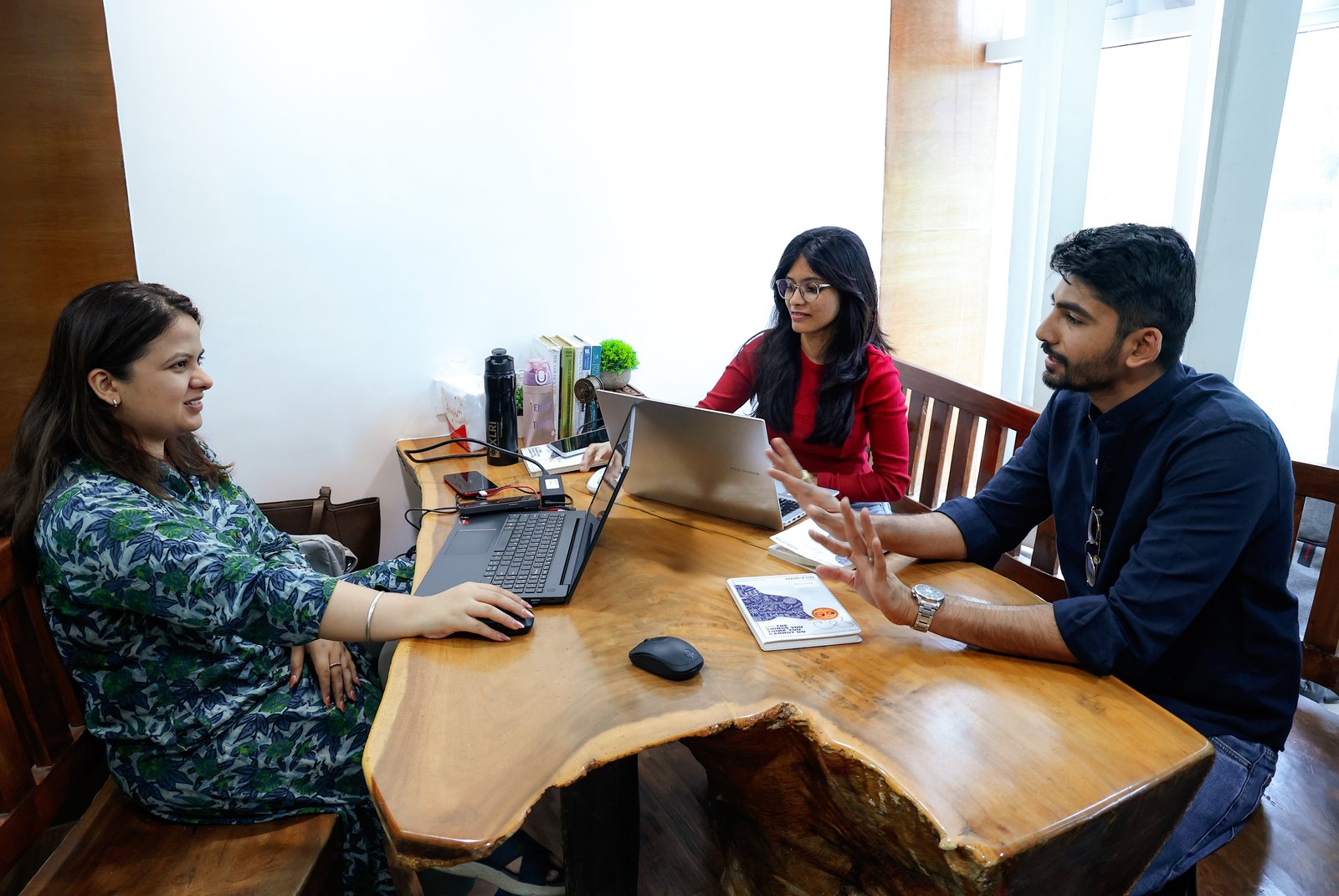 Two members of the MarketinCrew team working through a brief at a table