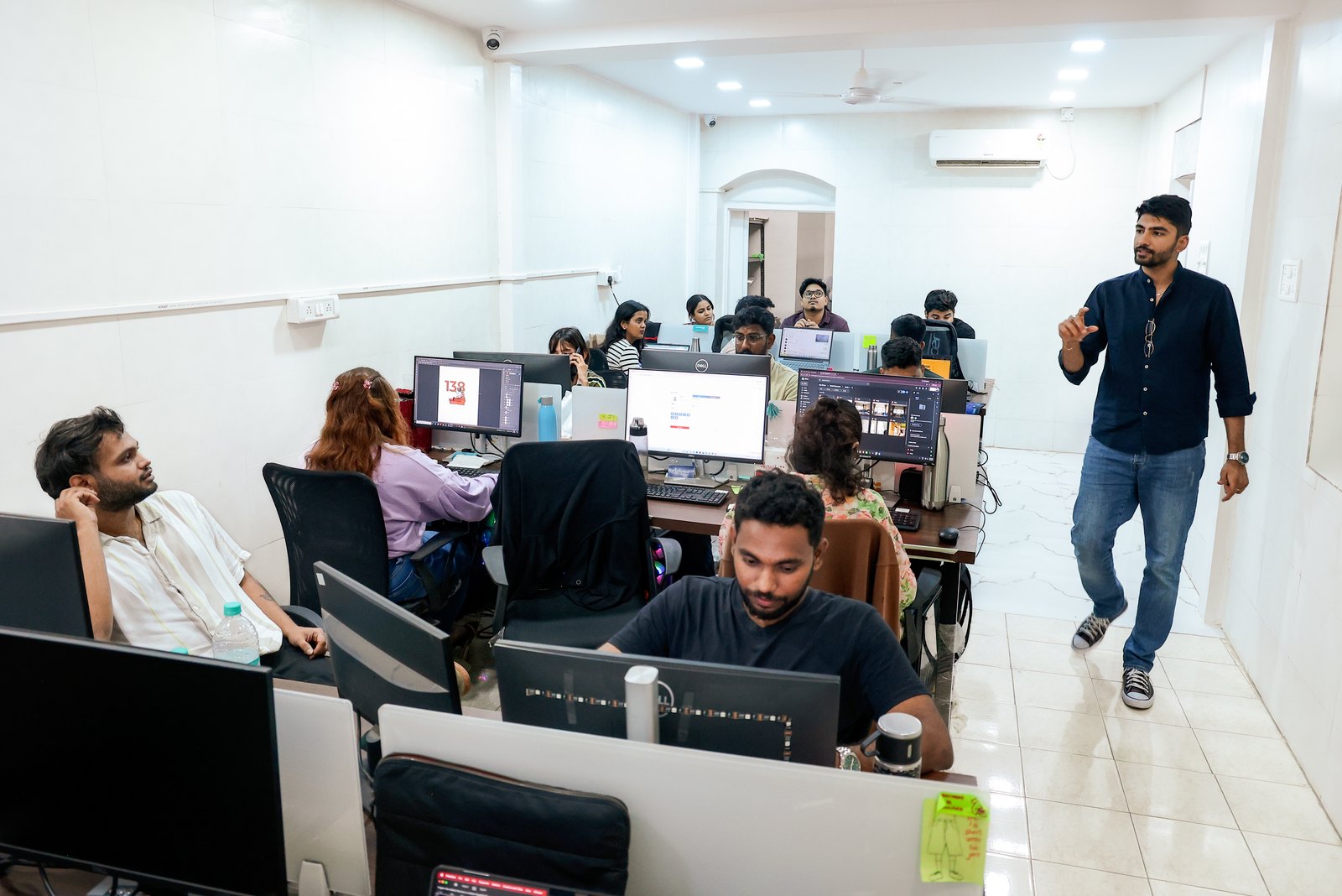 Manan Mehta walking through the MarketinCrew open-plan office in Mumbai